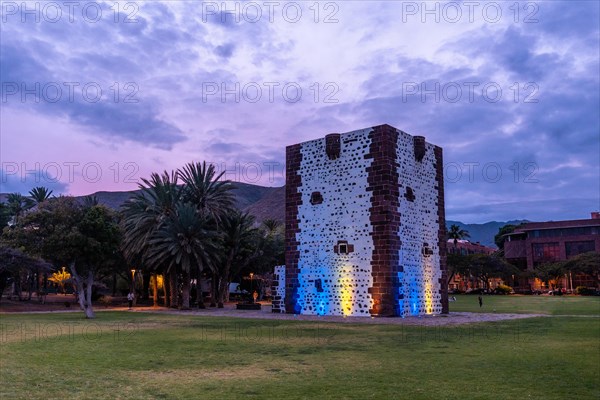 Beautiful park with the Torre del Conde illuminated at night in San Sebastian de La Gomera