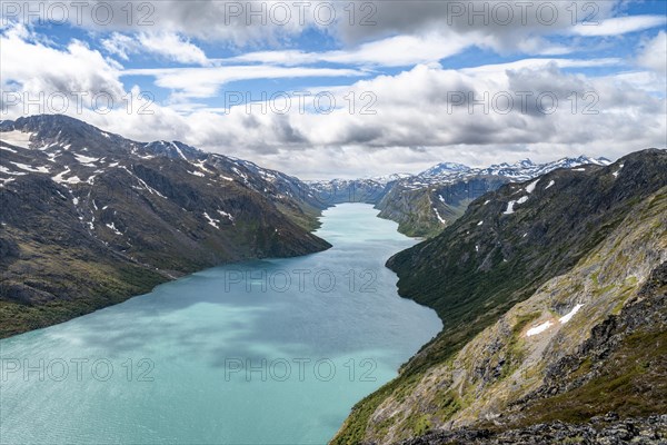 View of Lake Gjende and snowy mountains