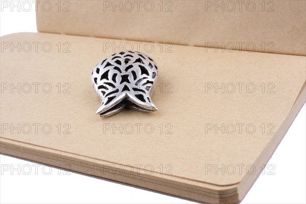 Silver tulip on a notebook on white background