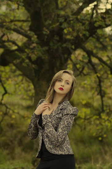 Beautiful young woman hands over heart looking away