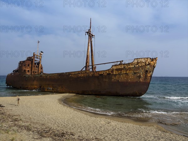 Rusty corroding Dimitrios shipwreck on a sandy beach near Gythio