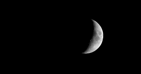 Waxing crescent moon seen with telescope