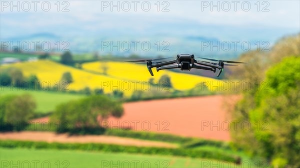 Drone in flight over fields and farms