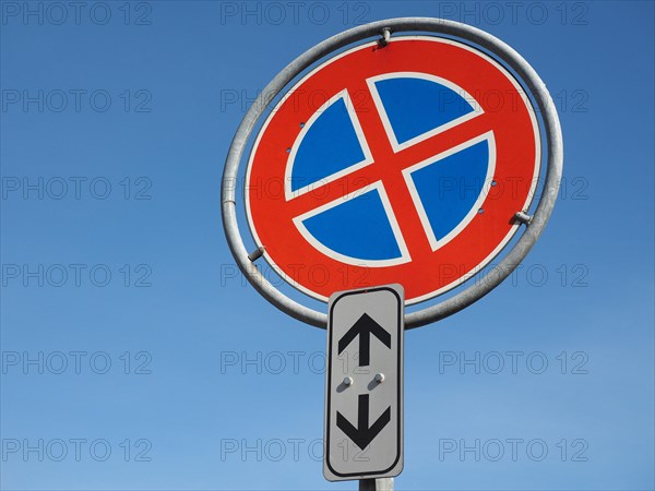 No parking and no stopping sign over blue sky with copy space