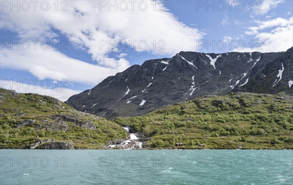 Lake Gjende with mountains and waterfall