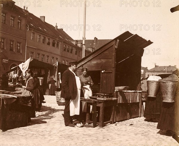 A man and a woman near a market stall