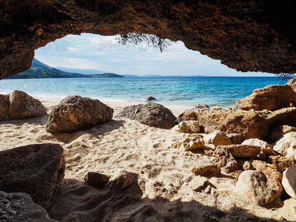 Karst cave on the sandy beach near the campsite of Stara Baska