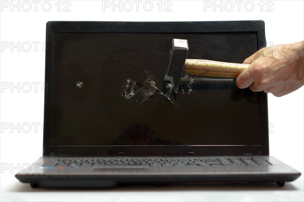 Arm of a man breaking a laptop with a hammer isolated on white background and copy space