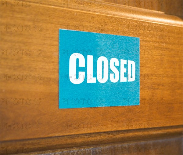 Closed sign on a wooden door
