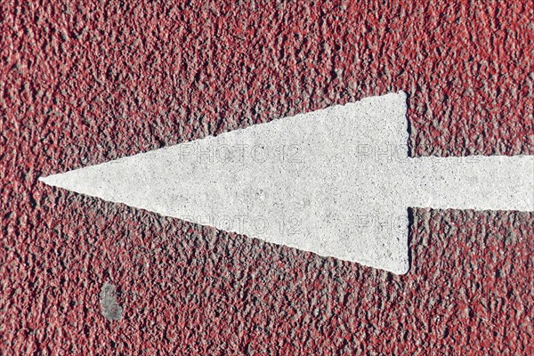 Ground marking directional arrow on a cycle path