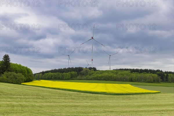 Wind farm in front of thunderstorm sky