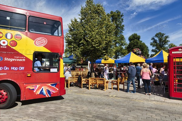 Street scene with double-decker bus and pedestrians