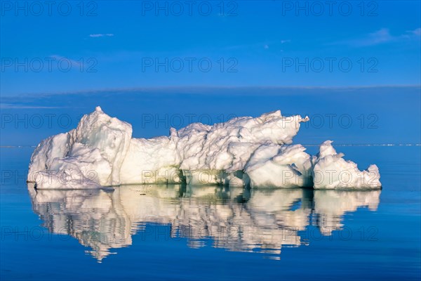 Melting Iceberg floating in the arctic sea