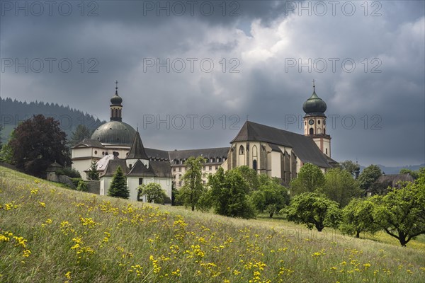 Thunderclouds pass over the Muenstertal and the monastery of Sankt Trudpert