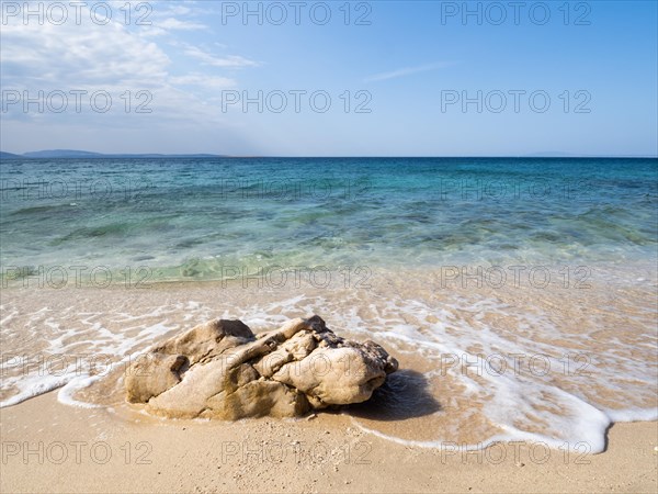 Rocks on the sandy beach near the campsite of Stara Baska