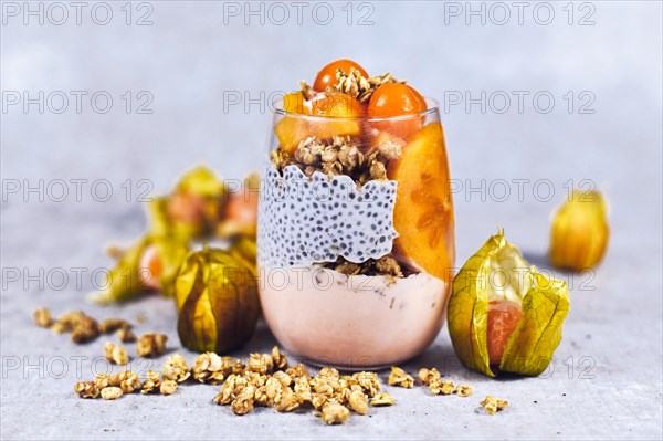 Healthy layered smoothie in glass with chia sees pudding