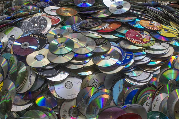 Old CD's collected for recycling in a container