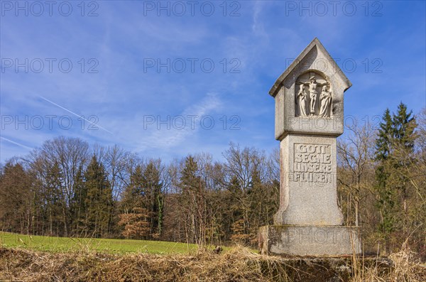 Wayside shrine on a field in spring