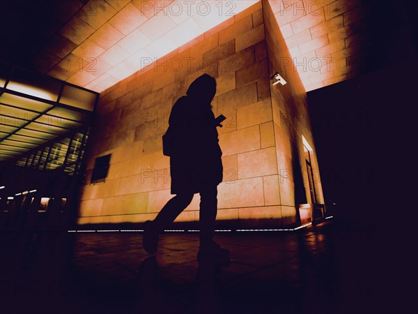 Silhouette of person on night city street