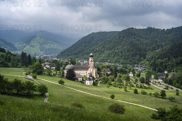 Thunderclouds pass over the Muenstertal and the monastery of Sankt Trudpert