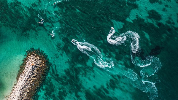 Aerial view on motorboat and jetski on the sea surface