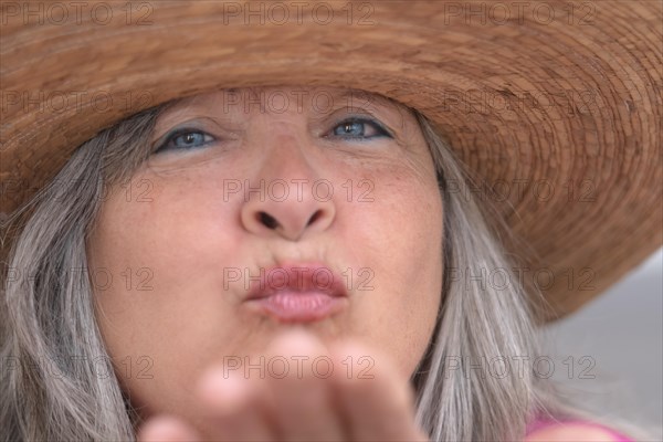 Close-up of an older woman with a hat