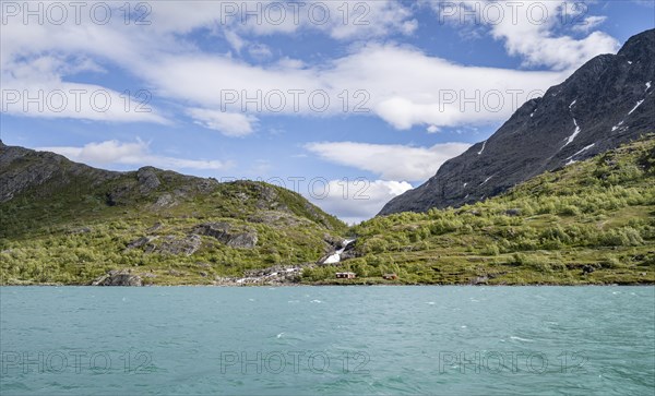 Lake Gjende with mountains and waterfall