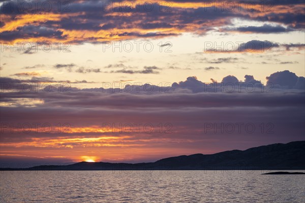 Dramatic sunset over the sea with archipelago island