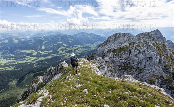 Mountaineer on a narrow ridge path