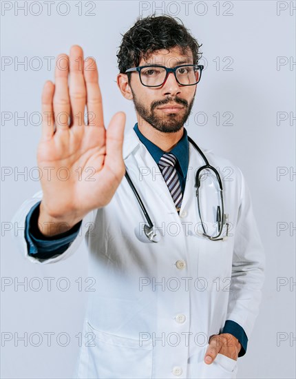Doctor making stop with a hand isolated. Young doctor making stop with the palm of the hand