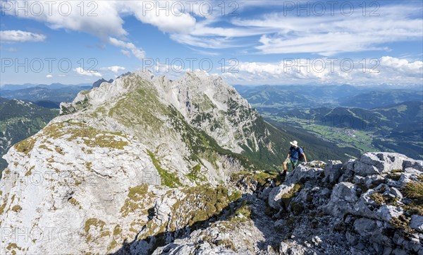 Mountaineer on a narrow ridge path