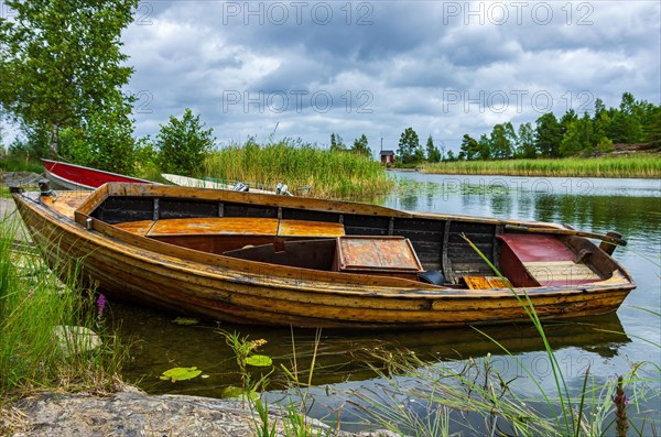 Small fishing boat at the edge of the lake