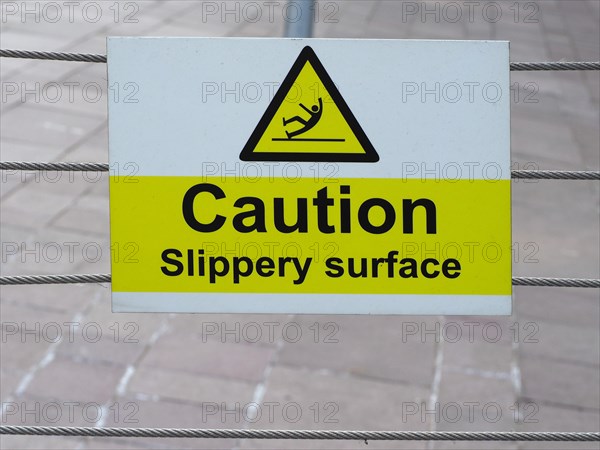 Caution slippery surface sign