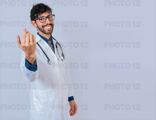 Smiling doctor inviting to come isolated. Young friendly doctor inviting to come on isolated background