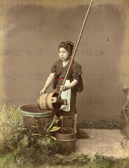 Woman drawing water from a well