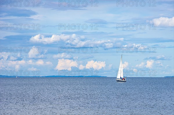 Lonely sailing boat in the distance in the Greifswalder Bodden