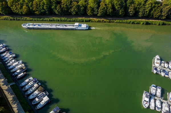 Drone shot of the Rhine-Herne Canal with cargo ship and sports boats