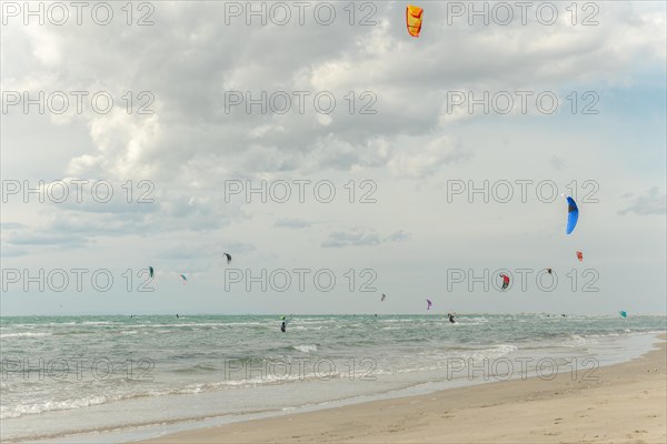 Beauduc beach with people kitesurfing. Salin de giraud