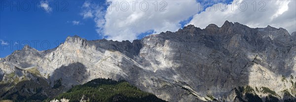 Play of light and shadow on the limestone mountain range of the Haut de Cry peak