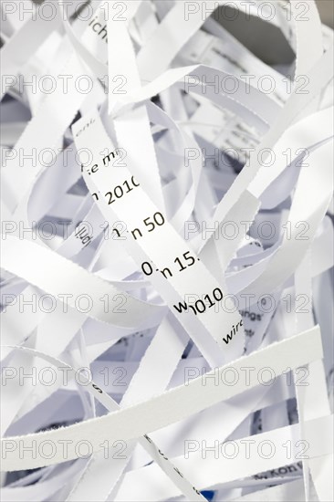 Paper strip documents made unrecognisable in the shredder