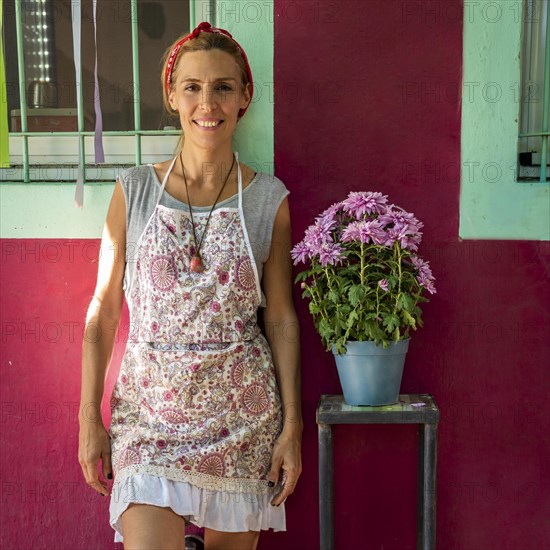 Portrait of a smiling entrepreneur in apron outdoors