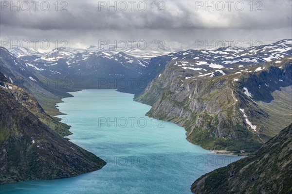 View of Lake Gjende and snowy mountains