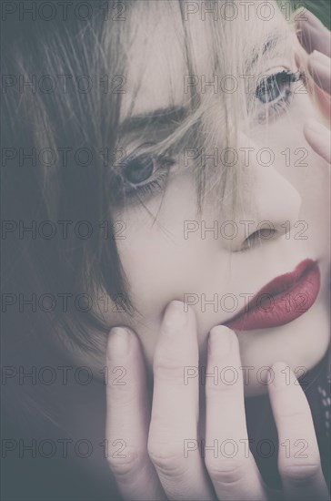 Beautiful young woman hands touching face looking away