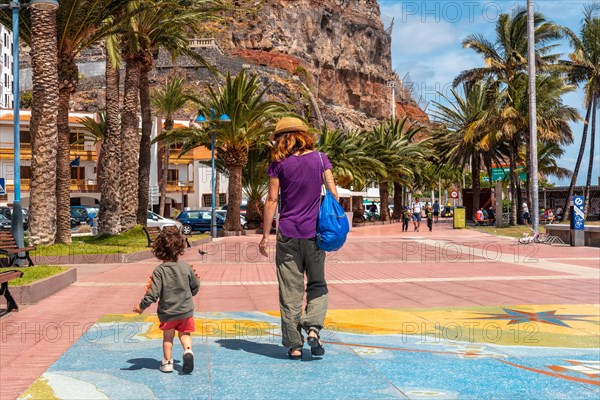 Walking along the promenade in the city of San Sebastian de la Gomera and its Iglesia De La Asuncion