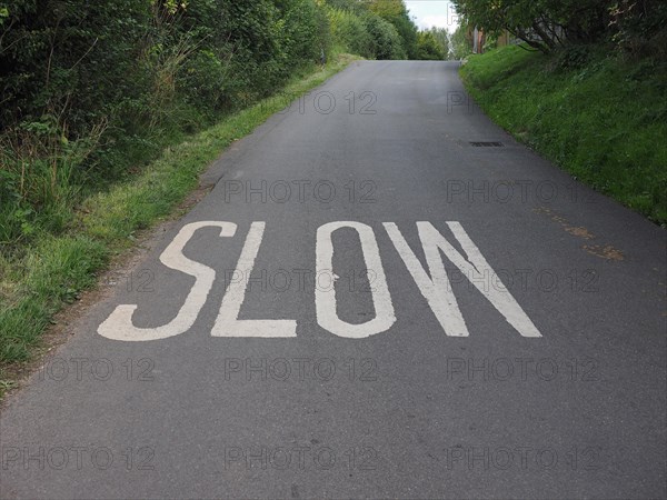 Slow sign painted on tarmac on a british road