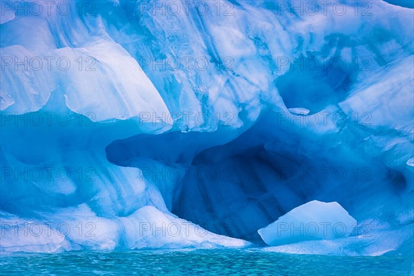 Colorful Glacier ice with a cave by the sea in Arctic