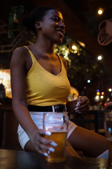 African woman in pub gather