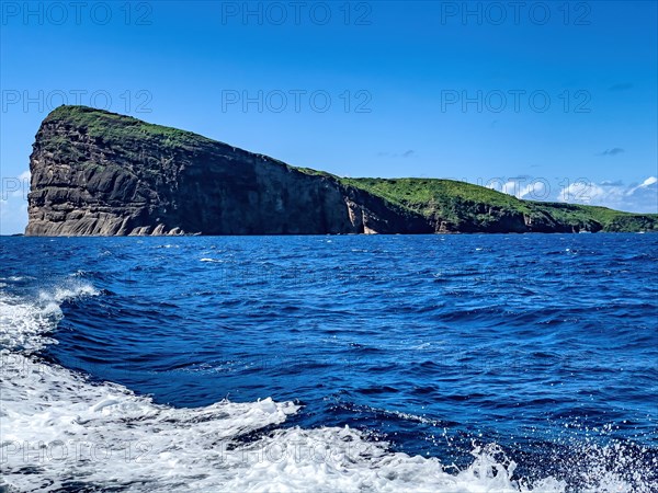 View of steep cliffs from Isle de Coin de Mire Gunner's Coin Island of lava lava rock off north coast of Mauritius in Indian Ocean