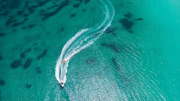 Aerial view on motorboat and jetski on the sea surface