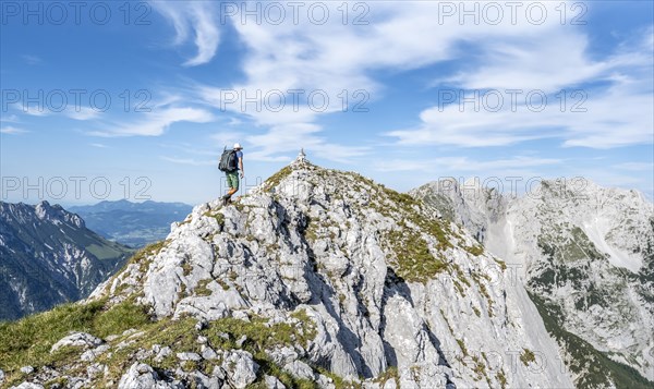 Mountaineer on a narrow ridge path